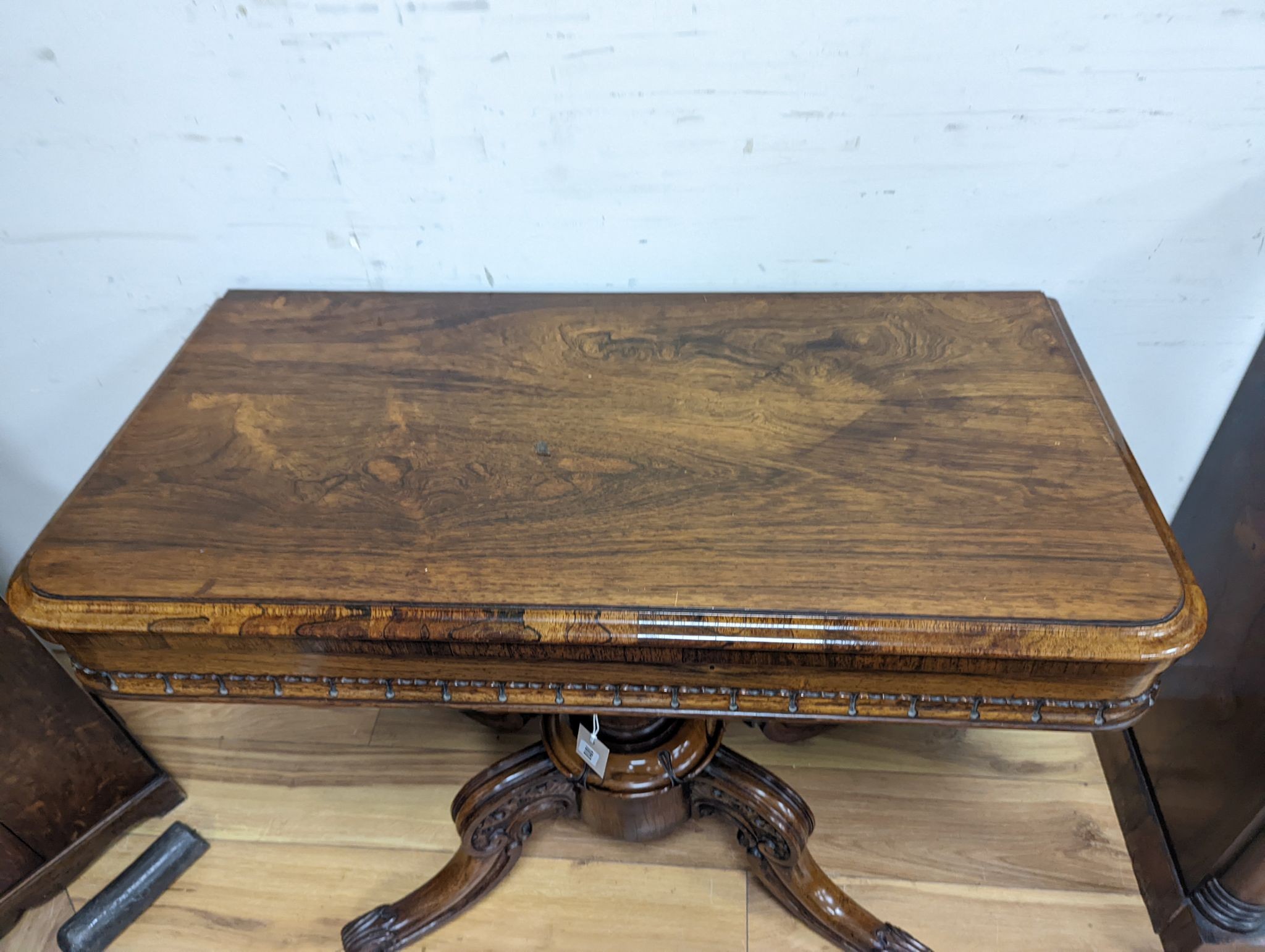 A good William IV rectangular rosewood folding card table, stamped with makers mark internally ‘T. Phillips, cabinet & chair manufacturer, 18 Finsbury Place, South Finsbury Square, London’ width 91cm, depth 45cm, height